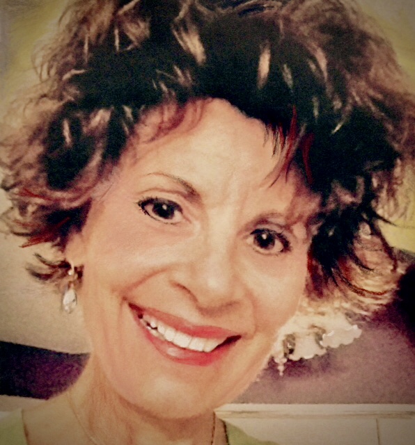 A woman with short hair smiles for the camera.