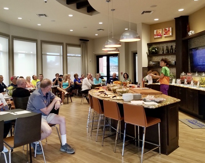 A group of people sitting at tables in a room.